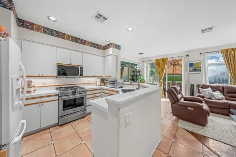 a kitchen with kitchen island granite countertop a sink and white appliances
