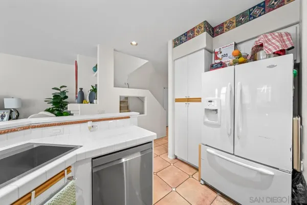 a kitchen with a refrigerator and a sink