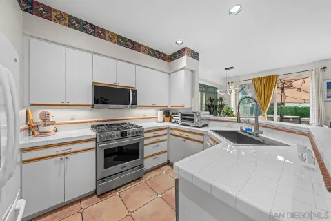 a kitchen with stainless steel appliances granite countertop a stove and a sink