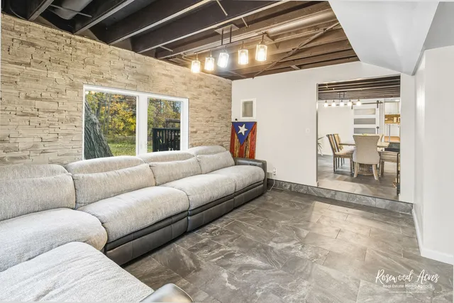 a living room with furniture and a chandelier
