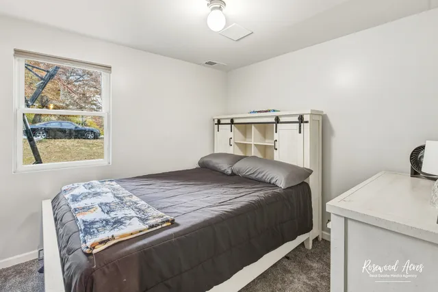 a bedroom with a bed and a window