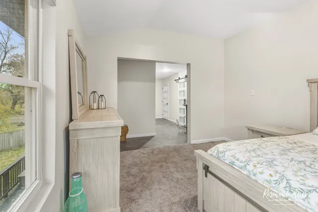 a en suite bathroom with a granite countertop sink and a mirror