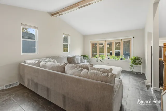 a living room with furniture and windows