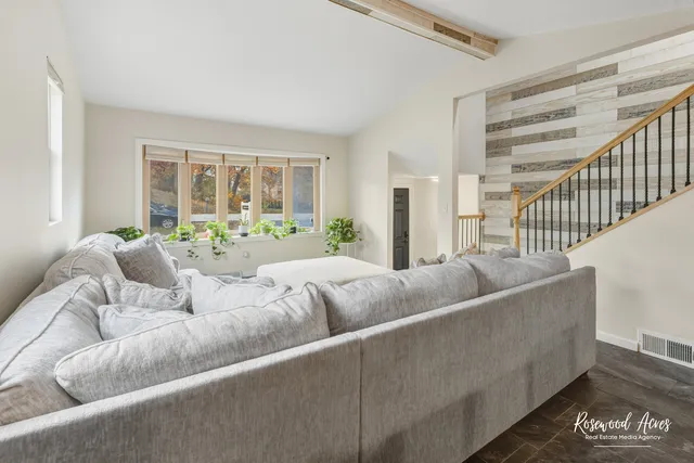 a living room with furniture and a large window