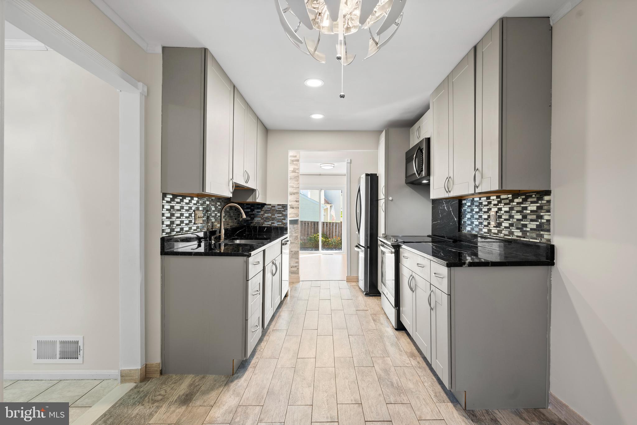 14801 Hammersmith Circle Silver Spring, MD 20906 - Photo 5 of 29 a kitchen with granite countertop a sink and cabinets