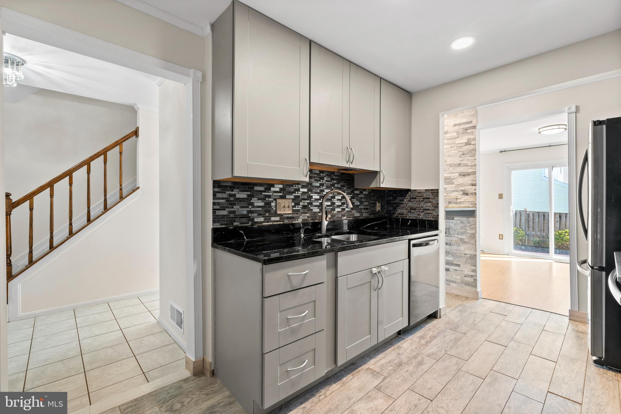 14801 Hammersmith Circle Silver Spring, MD 20906 - Photo 6 of 29 a kitchen with stainless steel appliances a sink stove and cabinets