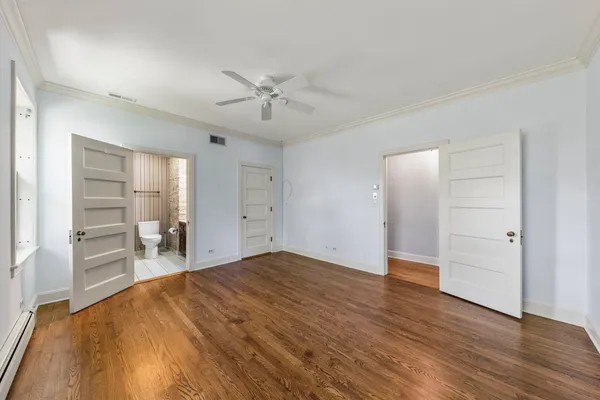 a view of empty room with wooden floor