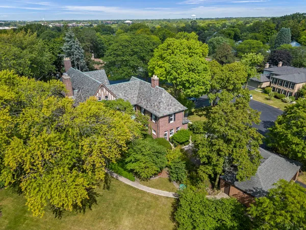 an aerial view of a house with a yard