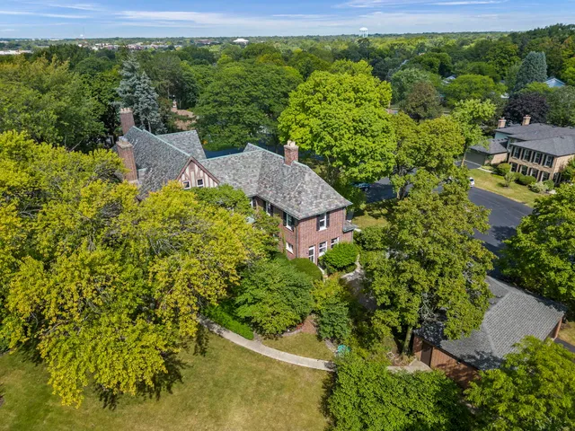 an aerial view of a house with a yard