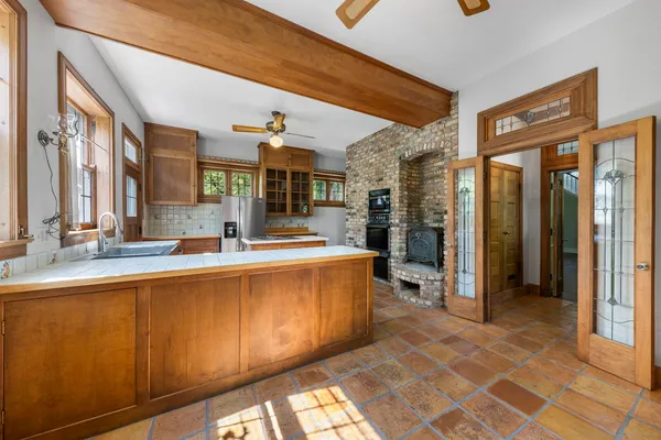 a large kitchen with stainless steel appliances granite countertop a refrigerator and a sink
