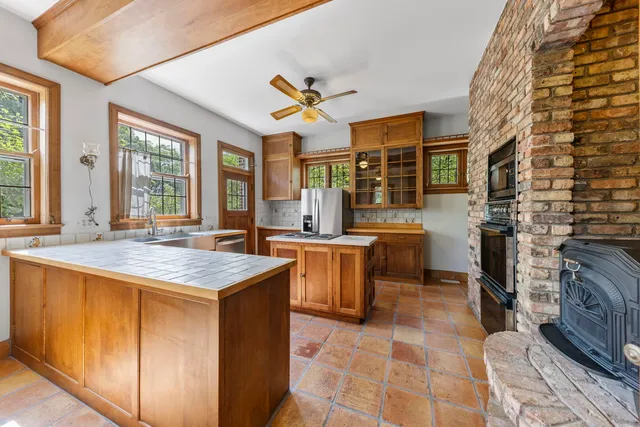 a kitchen with a sink a counter top space and stainless steel appliances