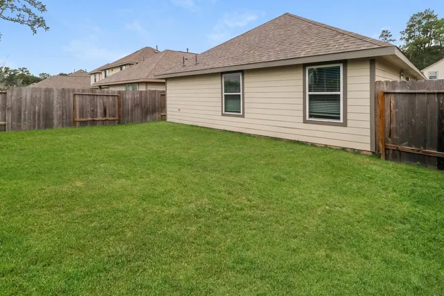 a view of a house with yard and a garden