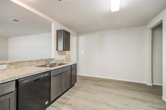a view of a kitchen with a sink and dishwasher