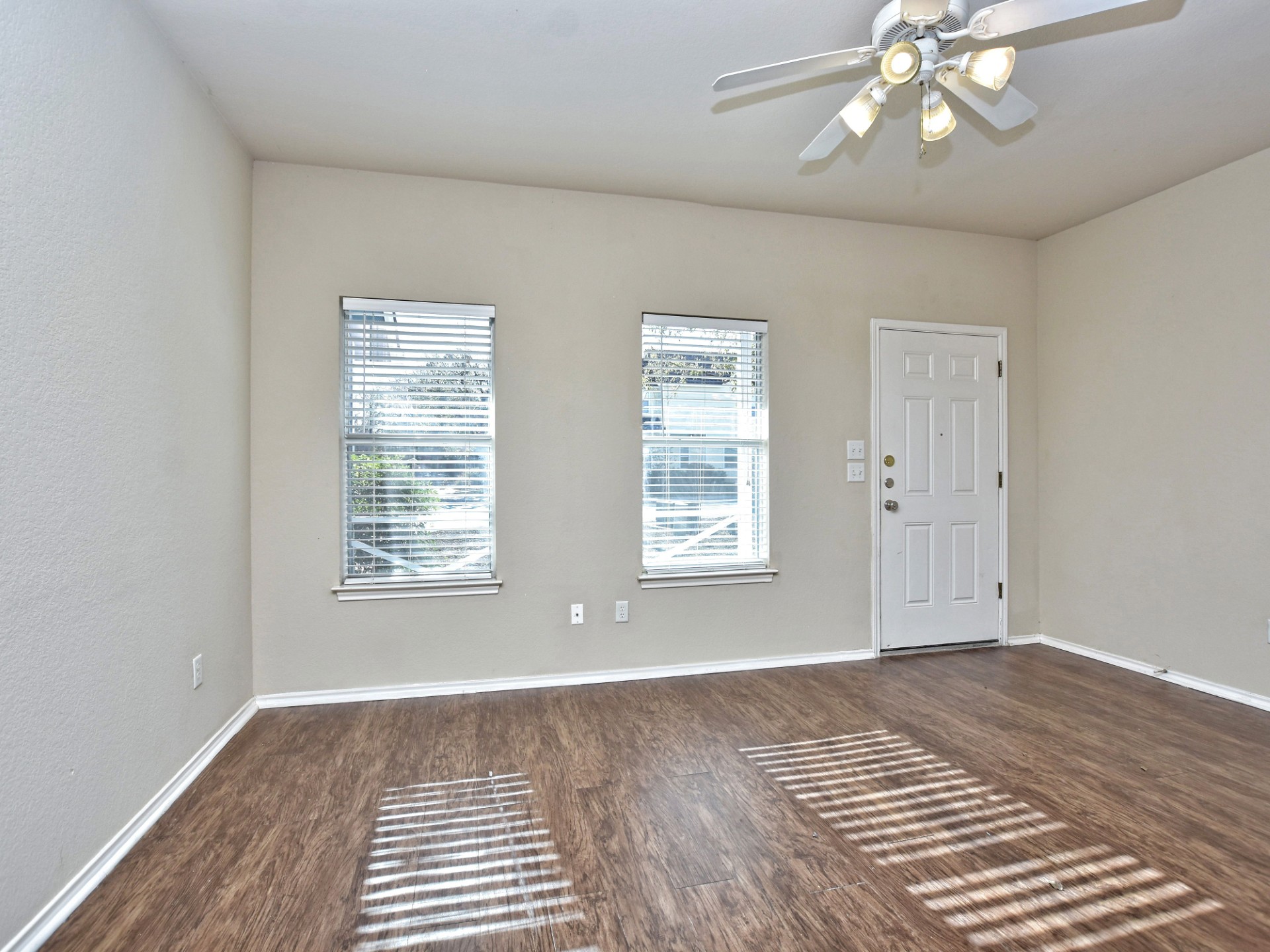 917 East 3rd Street Georgetown, TX 78626 - Photo 3 of 23 Sun-filled room boasts resilient wood flooring and a refreshing ceiling fan.