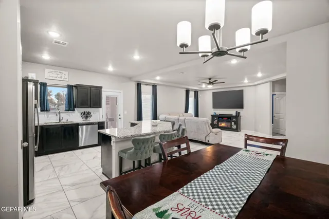 a large kitchen with a table and chairs