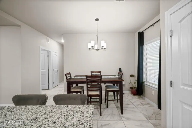 a view of a dining room with furniture and chandelier