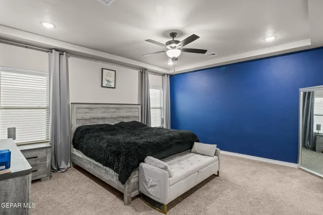 a bedroom with a bed lamp and a fireplace