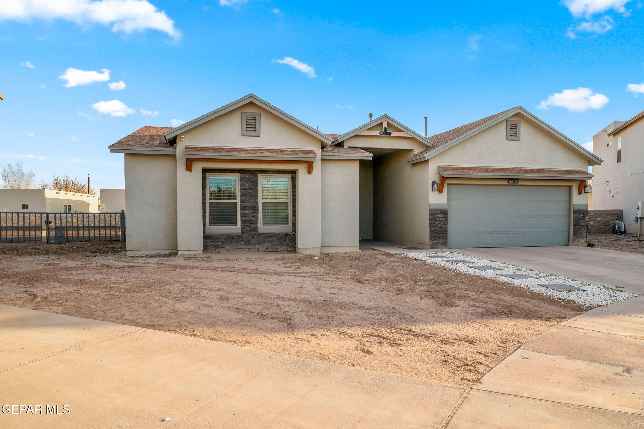 356 Plateau Drive Socorro, TX 79927 - Photo 2 of 51 a view of a house with a yard and garage