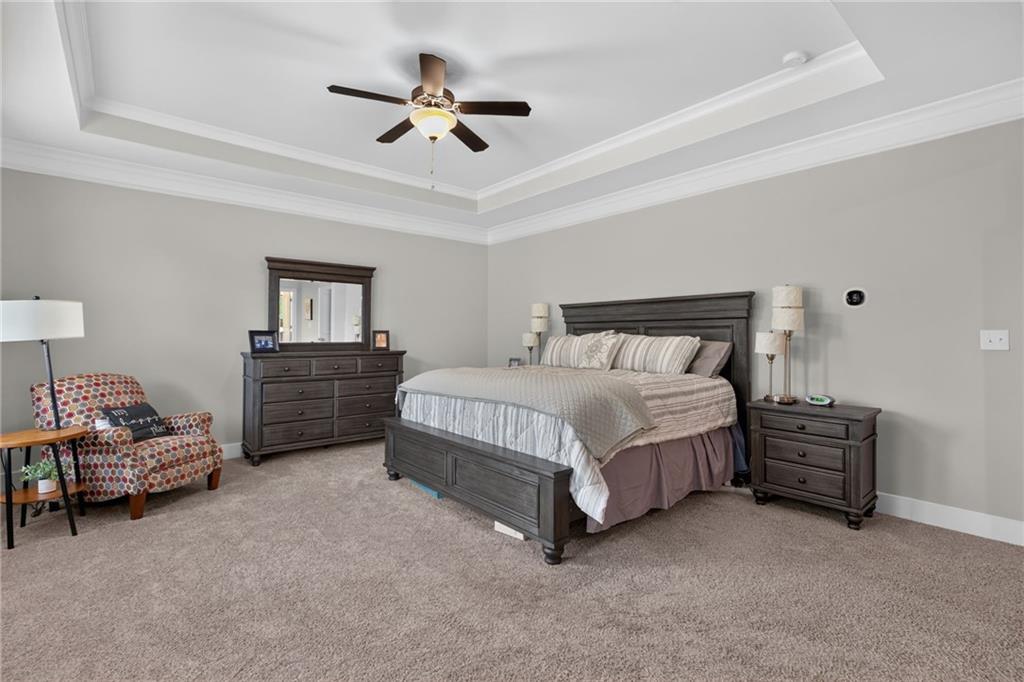 139 Manchester Lane Villa Rica, GA 30180 - Photo 30 of 60 a bedroom with a bed chandelier and a window
