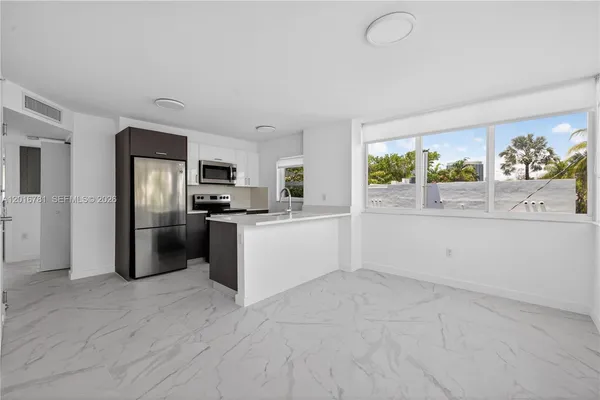 a kitchen with stainless steel appliances a refrigerator sink and stove