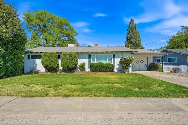 a front view of a house with a garden