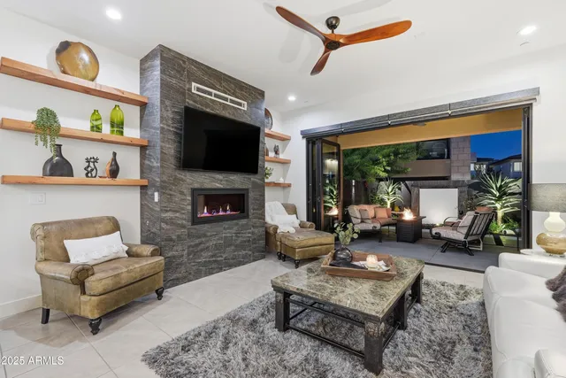 a living room with furniture and a floor to ceiling window