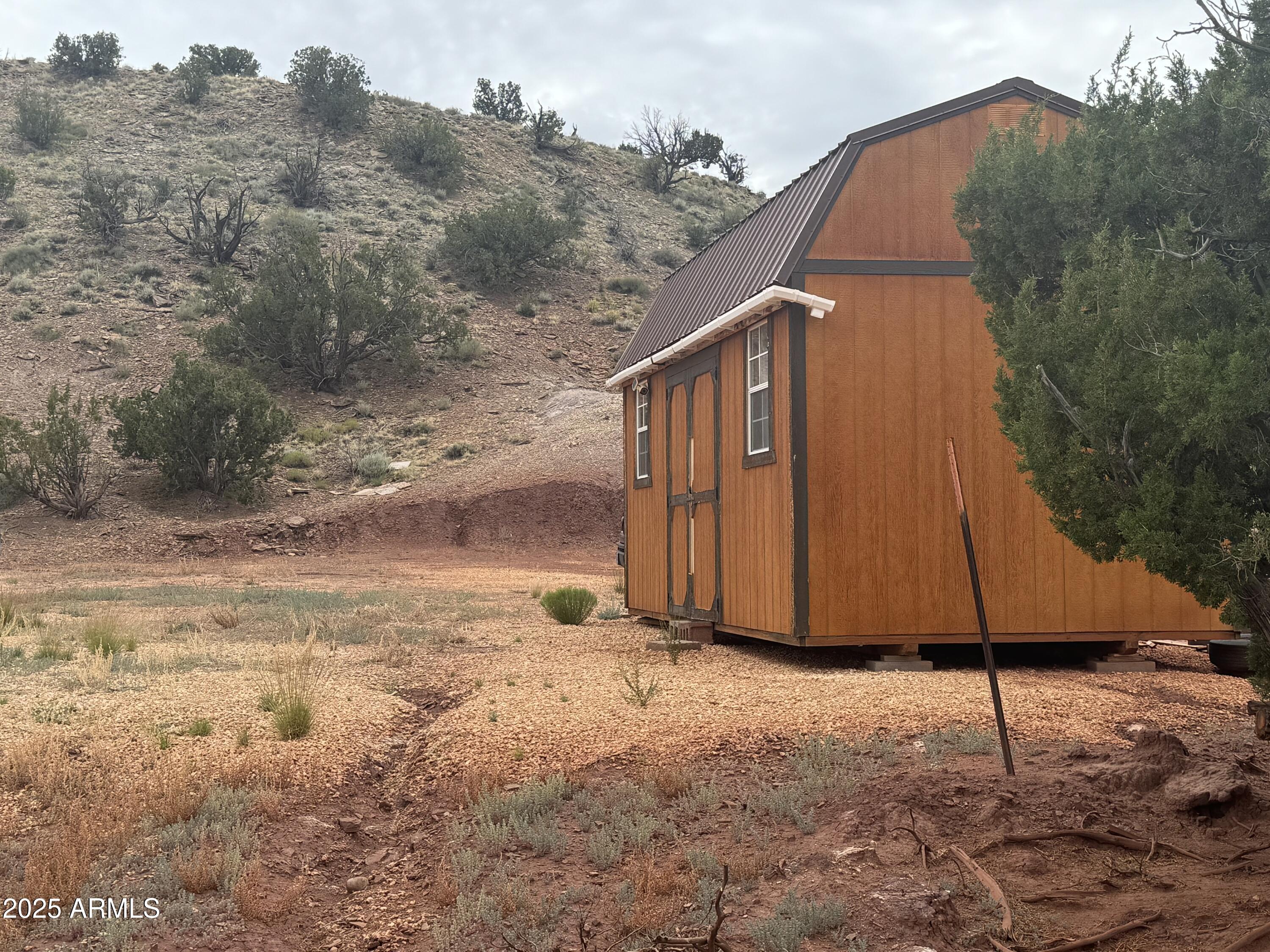 Lot 213 River Springs Ranch, Unit 213 St. Johns, AZ 85936 - Photo 2 of 8 a backyard of a house with wooden fence
