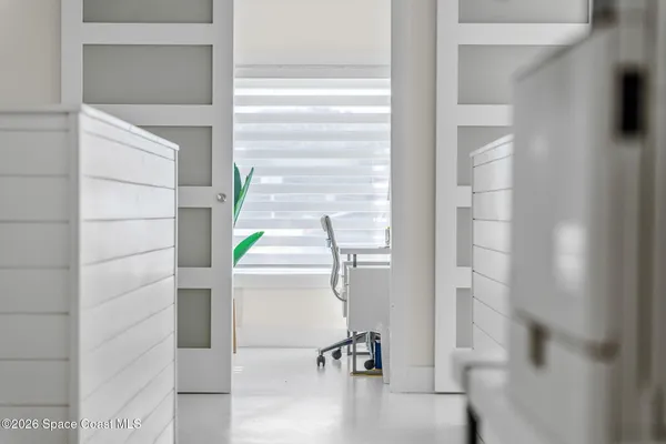 a view of a livingroom with furniture and an empty room
