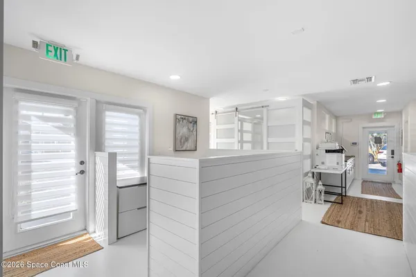 a view of a balcony with wooden chairs
