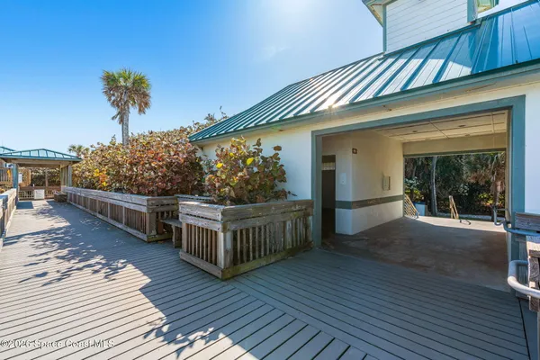 front view of a house with a large tree