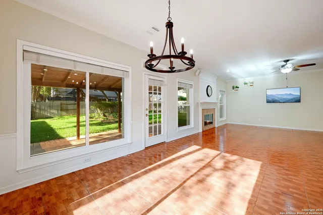 a very nice looking room with a large window and chandelier