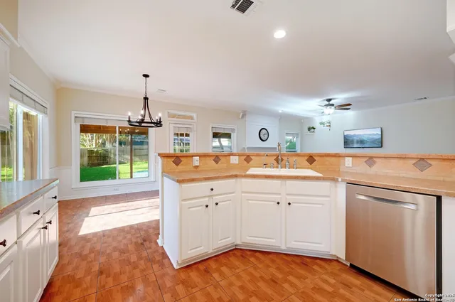 a kitchen that has a sink and a stove