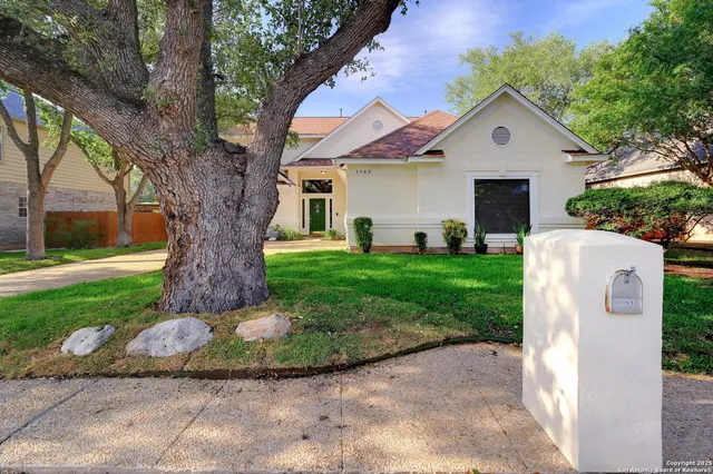 a front view of house with yard and green space