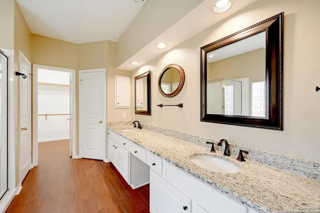 a bathroom with a granite countertop sink mirror and vanity