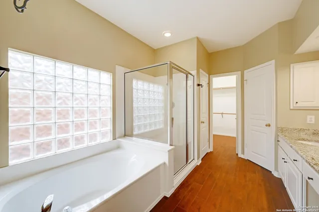 a spacious bathroom with a large tub and shower