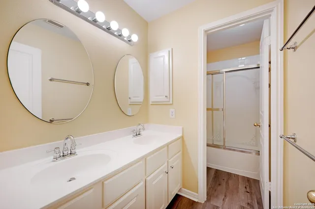 a bathroom with a double vanity sink mirror and double