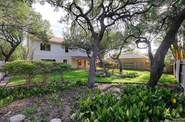 a view of a house with a yard and plants