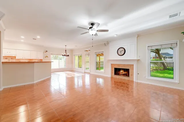 a view of an empty room with a fireplace and a window