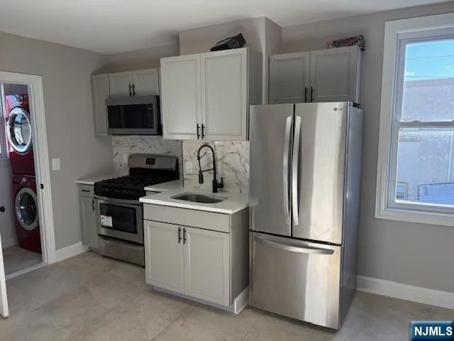 a kitchen with stainless steel appliances a refrigerator stove and microwave