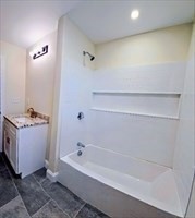 31 Niagara Street Fall River, MA 02721 - Photo 9 of 19 a bathroom with a bathtub and shower