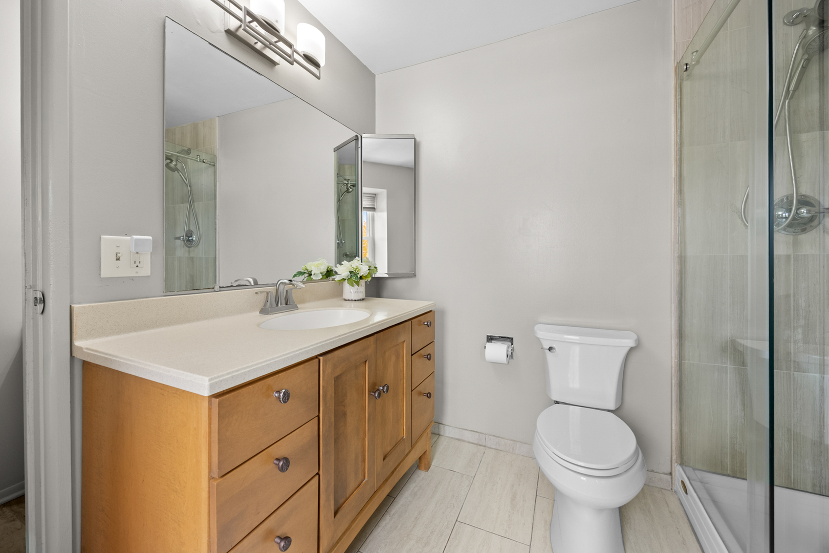 1567 California Street Elk Grove Village, IL 60007 - Photo 18 of 29 a bathroom with a sink a toilet and a mirror