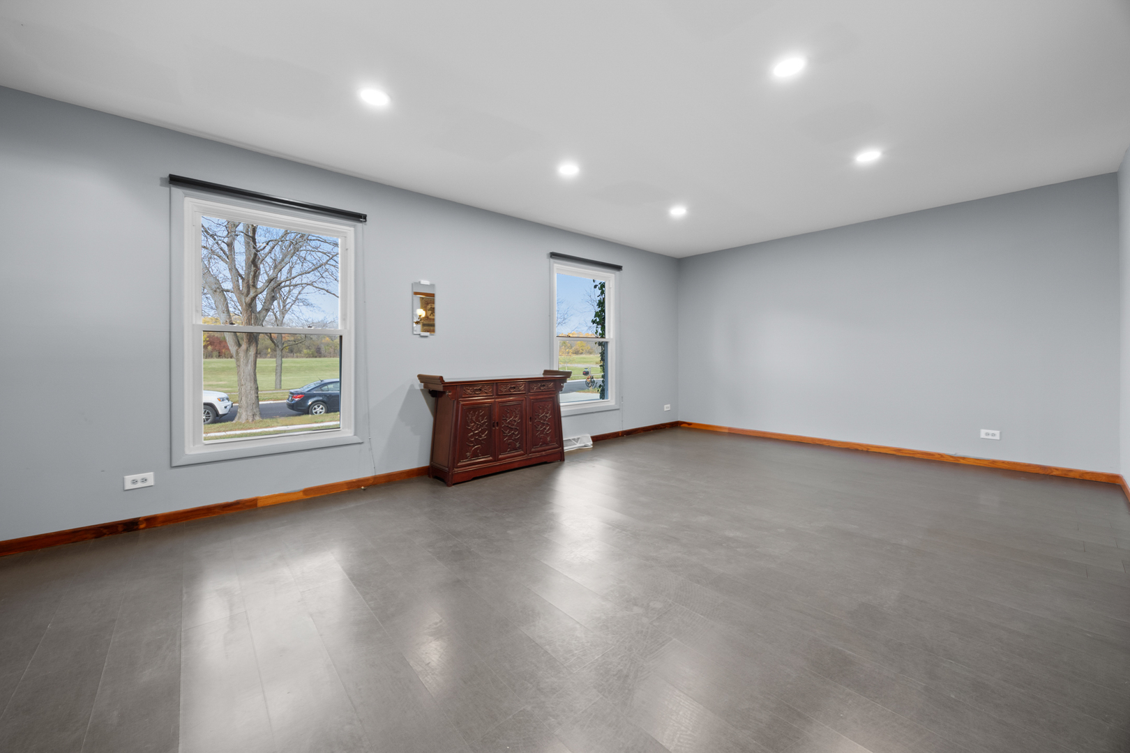 1567 California Street Elk Grove Village, IL 60007 - Photo 4 of 29 an empty room with wooden floor and windows