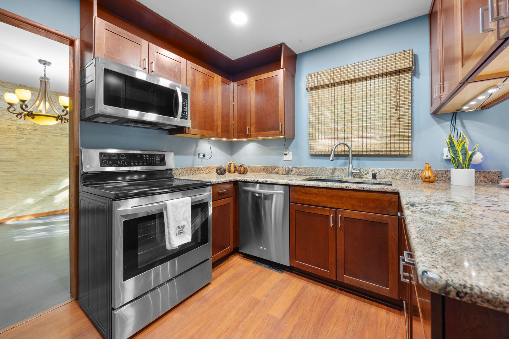 1567 California Street Elk Grove Village, IL 60007 - Photo 7 of 29 a kitchen with stainless steel appliances granite countertop a stove a sink and a microwave