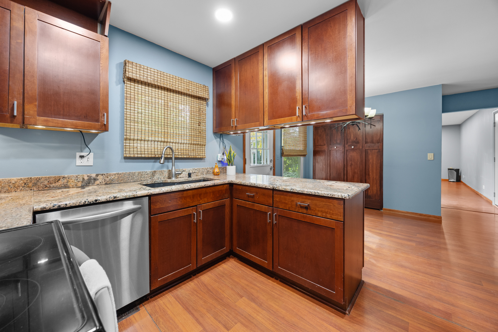 1567 California Street Elk Grove Village, IL 60007 - Photo 8 of 29 a kitchen with stainless steel appliances granite countertop wooden cabinets a sink and dishwasher with wooden floor