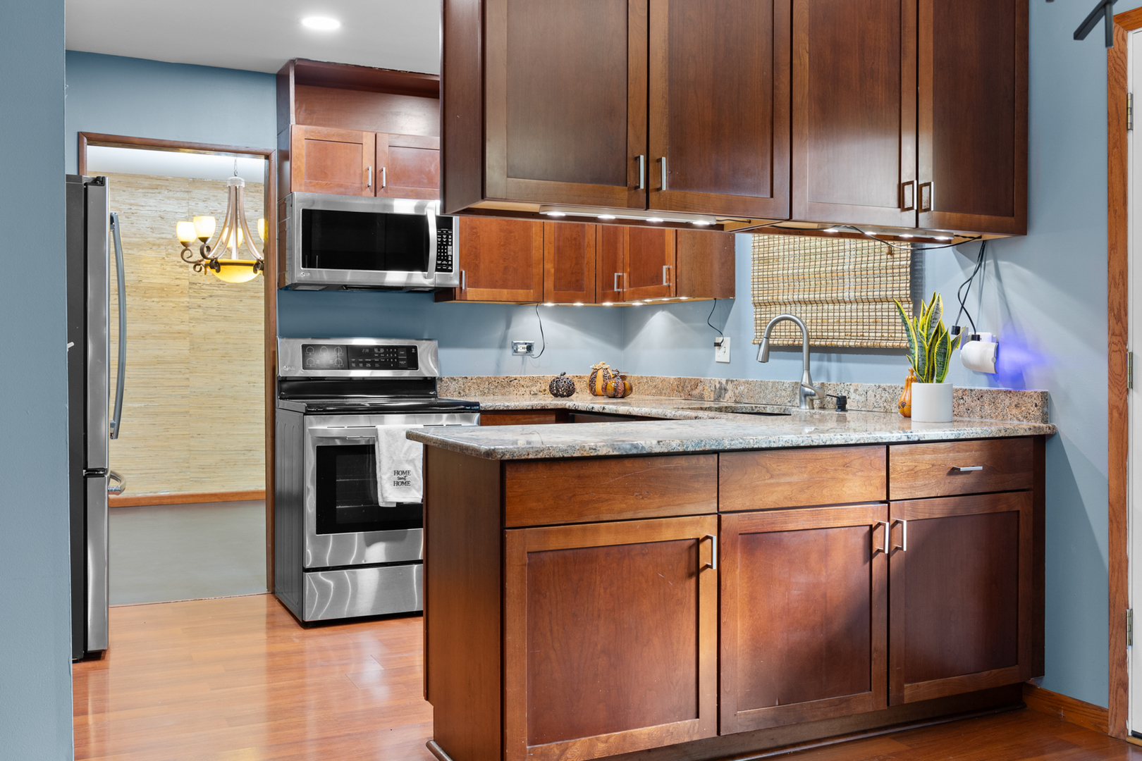 1567 California Street Elk Grove Village, IL 60007 - Photo 9 of 29 a kitchen with kitchen island granite countertop a sink a stove and a refrigerator