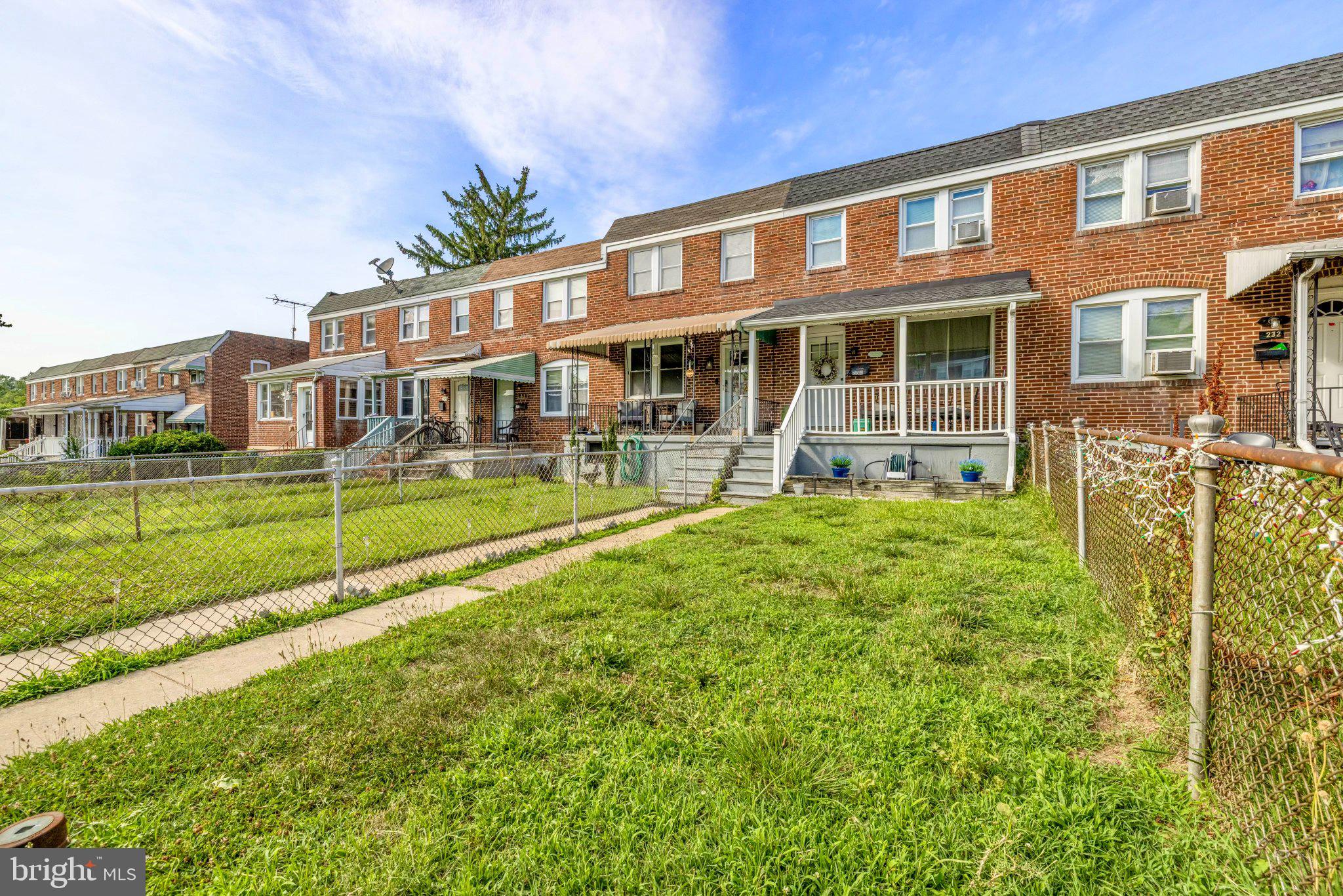 234 West Edgevale Road Baltimore, MD 21225 - Photo 38 of 45 Charming brick townhomes with greenery.
