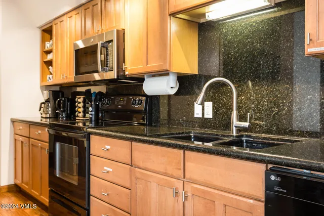 a close view of a sink and a granite counter top