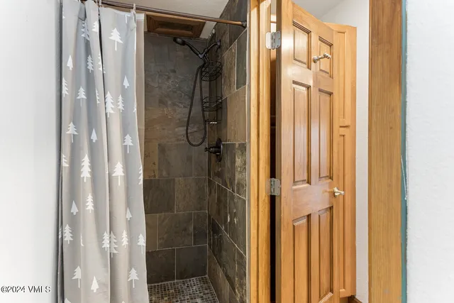 a bathroom with a glass shower door