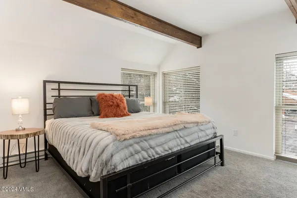 a bedroom with a bed and a night stand