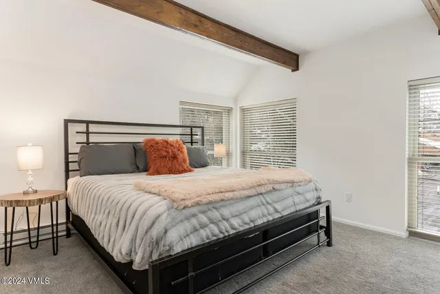 a bedroom with a bed and a night stand